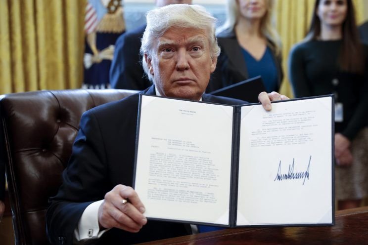 FILE: President Donald Trump of America displays the executive order banning citizens of seven countries from entering the US