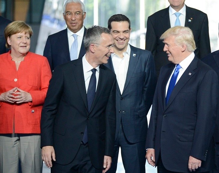 Trump speaks with NATO secretary-general, Jens Stoltenberg. Left is Germans leader, Merkel