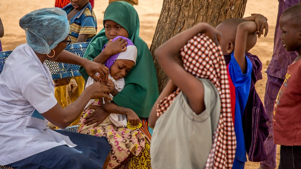 FILE: A nurse vaccinating children against measles.