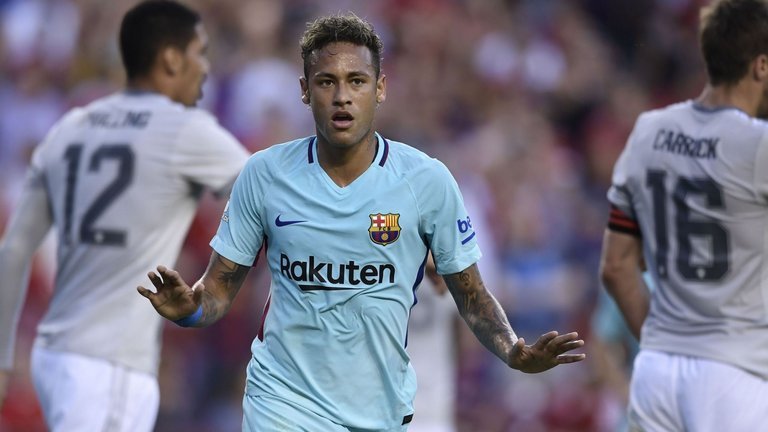 Neymar celebrates scoring for Barcelona in the first half