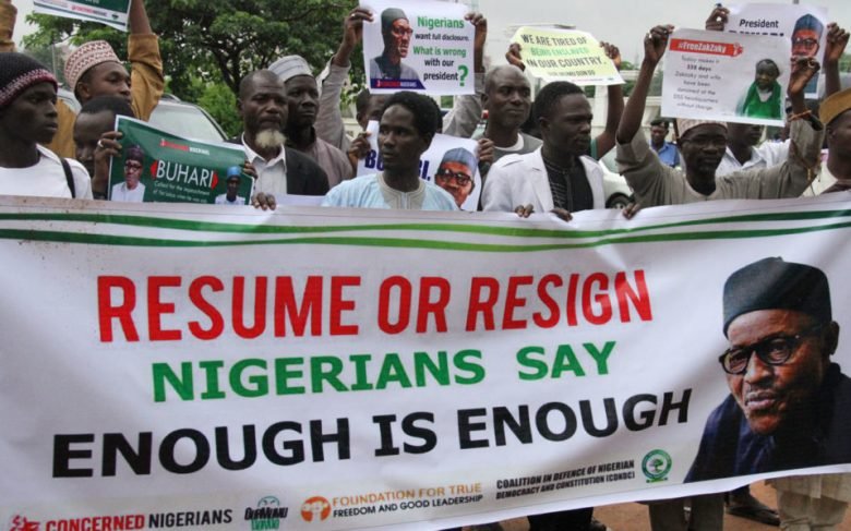 Protesters carry placards to demand that ailing President Mohammadu Buhari resume work or resign in Abuja