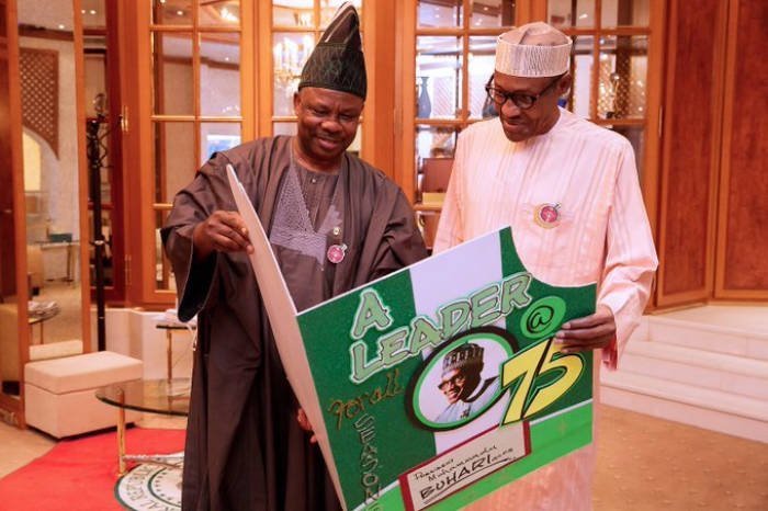 FILE PHOTO: Governor Ibikunle Amosun presenting a birthday card to President Muhammadu Buhari in 2017