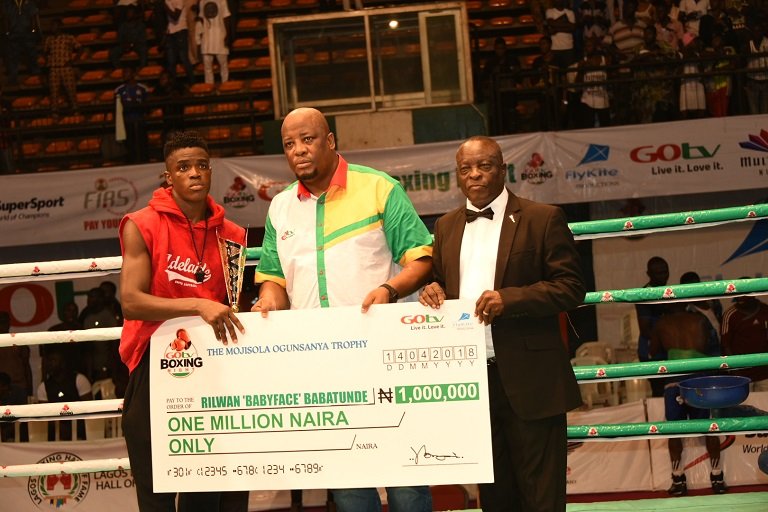 FILE: Rilwan "Baby Face" Babatunde receiving cheque a of one million naira from Martin Mabutho, General Manager (Marketing and Sales), MultiChoice Nigeria; and Dr. Rafui Ladipo, President, NBBof C, at GOtv Boxing Night 14