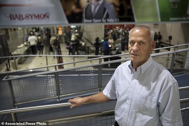 In this May 22, 2018, photo provided by the Institute for Justice in Arlington, Va., Rustem Kazazi poses for a portrait in Cleveland Hopkins International Airport in Cleveland. Kazazi, a U.S. citizen who immigrated from Albania in 2005, says in a lawsuit filed Thursday, May 31, 2018, that U.S. agents seized his life savings of $58,000 at the airport in October 2017, and the government has refused to return the money even though Kazazi faces no charges. A spokesman for the Customs and Border Protection said the agency doesn’t comment on pending lawsuits. (Isaac Reese/Institute for Justice via AP)