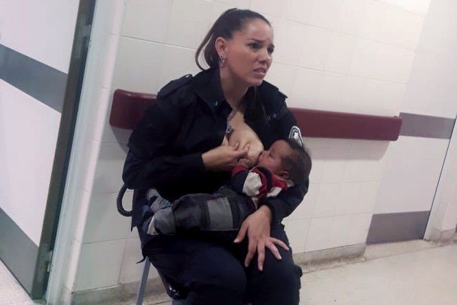 Argentine police officer Celeste Ayala breast feeding a neglected baby in a photo that has gone viral on social media