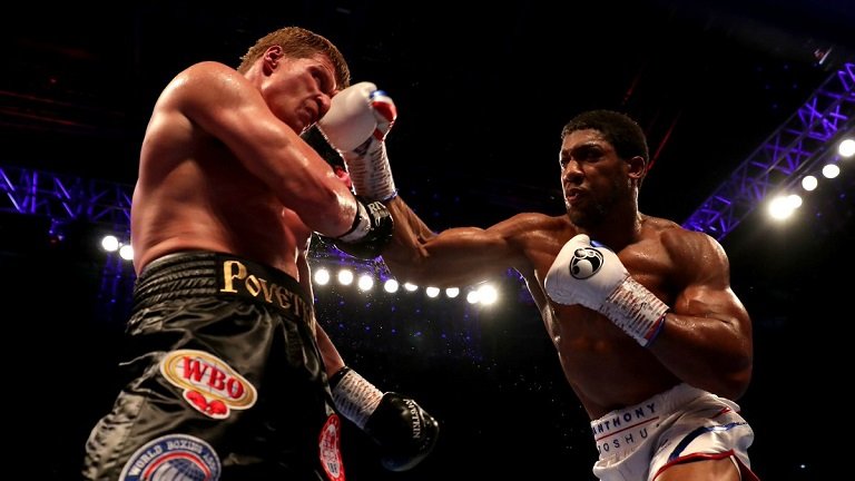 Anthony Joshua knocks out Alexander Povetkin in the seventh round of their heavyweight fight in Wembley