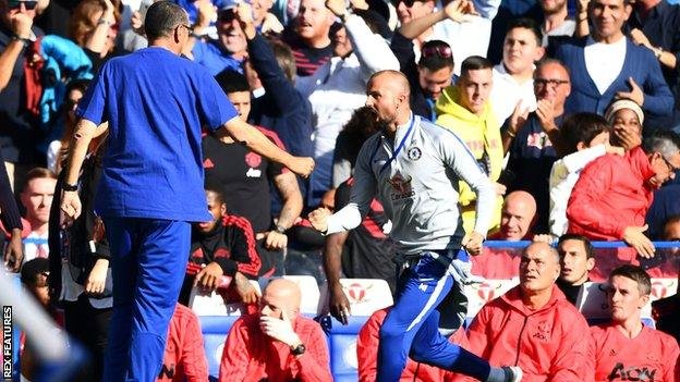 Chelsea assistant coach Marco Ianni runs past the Manchester United bench after Ross Barkley scored a late equaliser