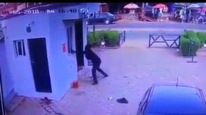 A robber throws a dynamite into the ATM room in an Offa bank