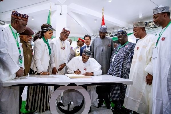 President Buhari signs visitor’s book at the airport terminal