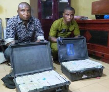 Suspected money launderers Ezekwe Emmanuel (L) and Igboh Augustine (R) arrested with $2.8 million at Akanu Ibiam Int'nl Airport,Enugu