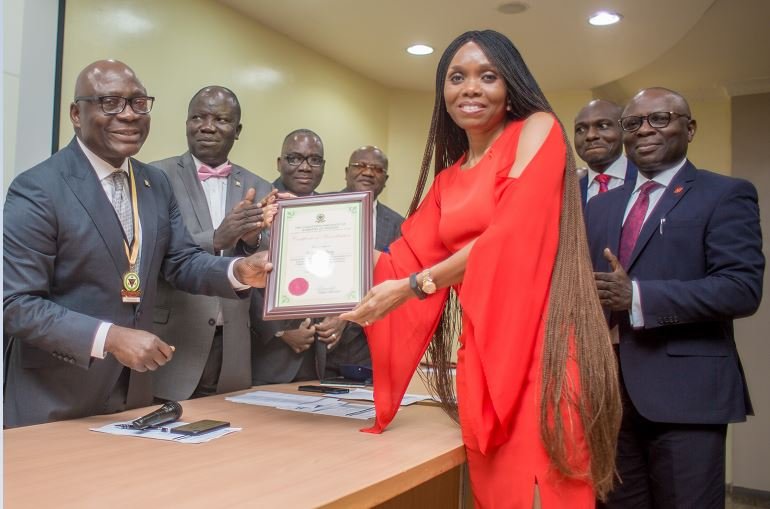 UBA Group Head Human Resources, Mrs Patricia Aderibigbe receiving the Certificate of Accreditation to UBA Academy