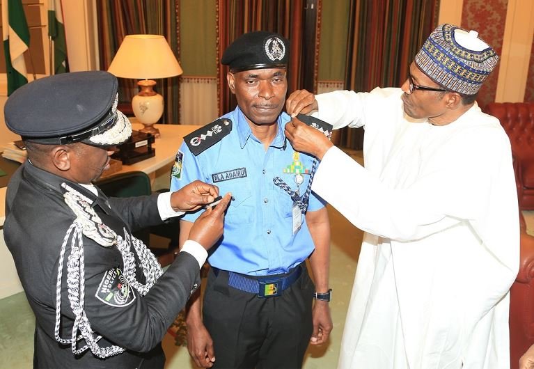 President Buhari and outgoing Inspector General of Police, Ibrahim Idris decorate Mohammed Adamu as new Inspector General of Police