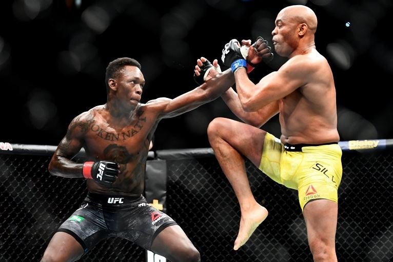 Israel Adesanya lands a punch to the face of his idol, 43-year-old Anderson Silva, at UFC 234