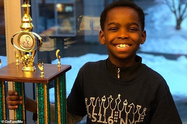 Tanitoluwa Adewumi pictured with his trophy after he won the state tournament for kindergarten through third grade last weekend