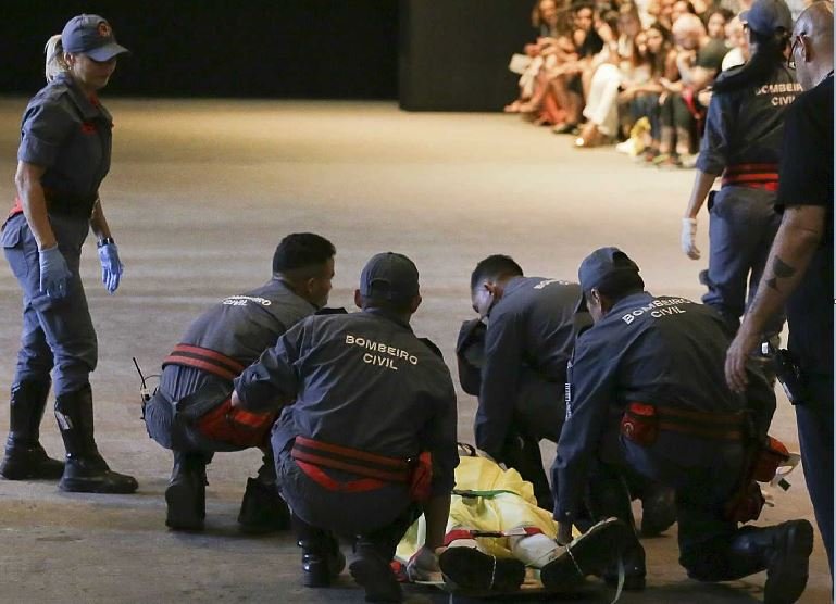 Model Tales Soares is taken from the catwalk by paramedics after he collapsed during Sao Paulo Fashion Week in Sao Paulo, Brazil, Saturday, April 27, 2019
