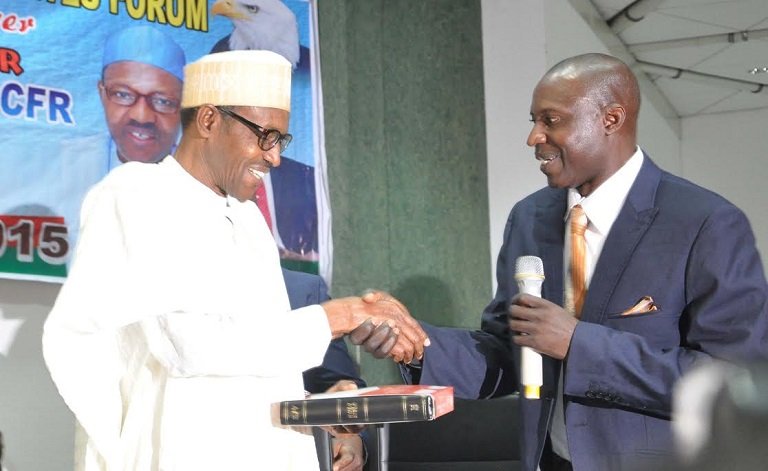 Pastor Habu Aminchi in a handshake with President Muhammadu Buhari in 2015