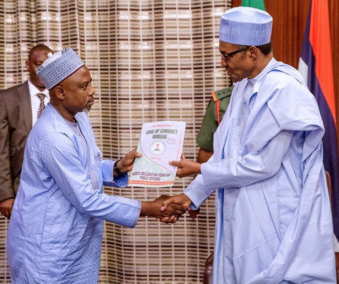 FILE PHOTO: President Muhammadu Buhari receiving his assets declaration form from CCB's Prof. Muhammed Isah