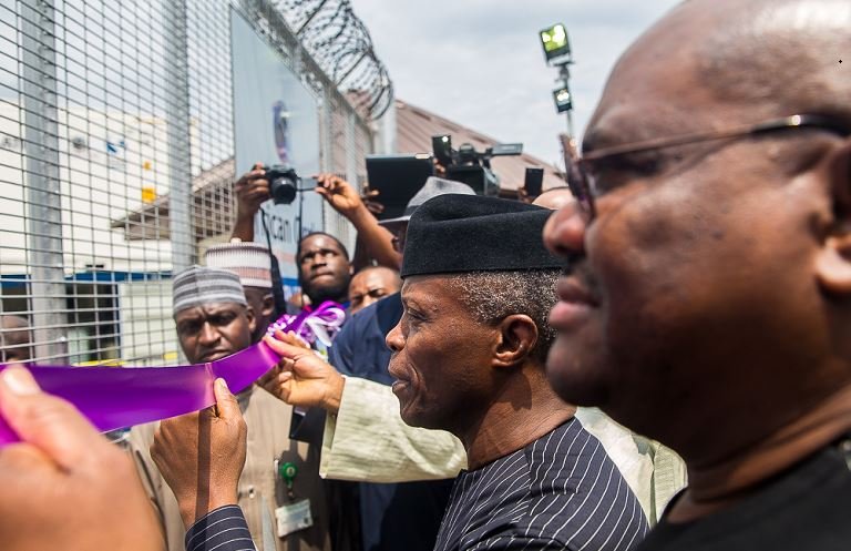 Vice President Yemi Osinbajo flanked by Gov. Rivers State, Ezenwo Nyesom Wike as he cuts the ribbon on commissioning the Liquid Waste Treatment Plant in Port-Harcourt