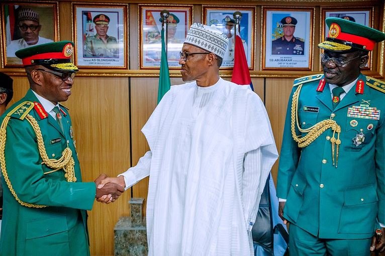 President Muhammadu Buhari flanked by Lt. Gen. Lamidi Adeosun and General Buratai