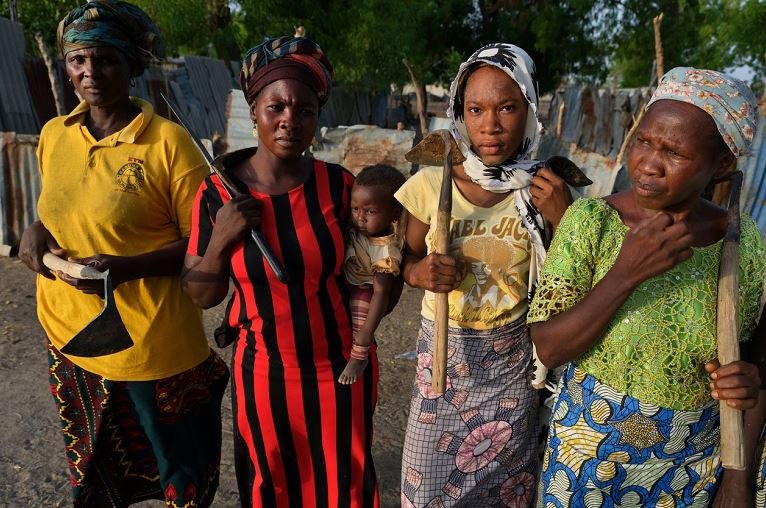 Sarah James, at left, with others living near the Maimalari barracks in Maiduguri. The women said they gave up land they had farmed for years to make way for the expansion of the base’s cemetery.