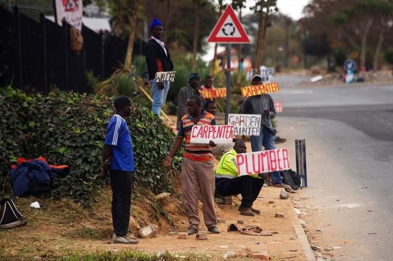 South Africans looking for jobs advertise on the road