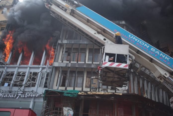 A policeman has been killed after a building was ravaged by fire