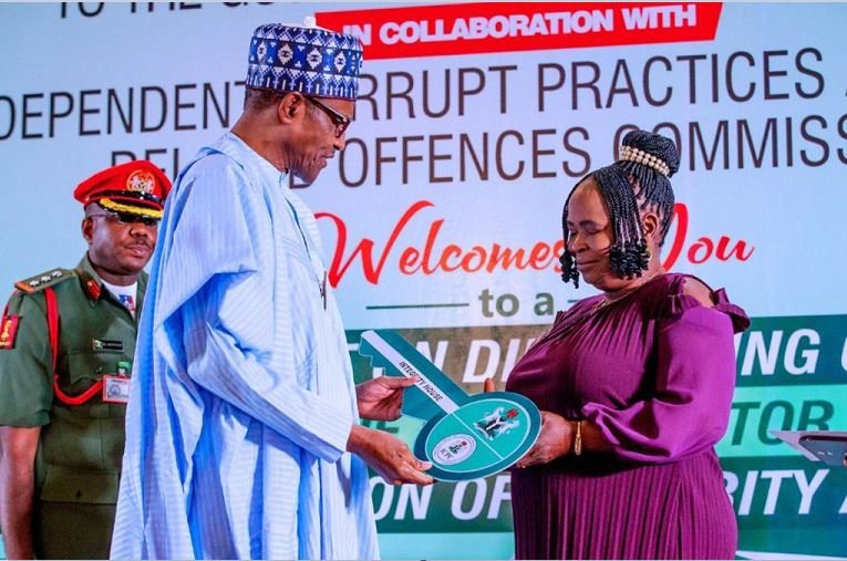 President Muhammadu Buhari honours Josephine Ugwu who returned N12million found at the airport