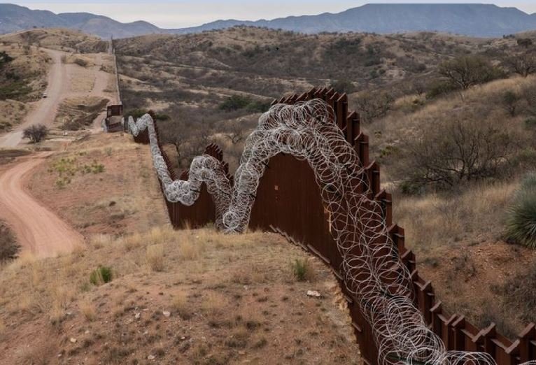 A border wall divides Nogales, Arizona from the Mexican state of Sonora