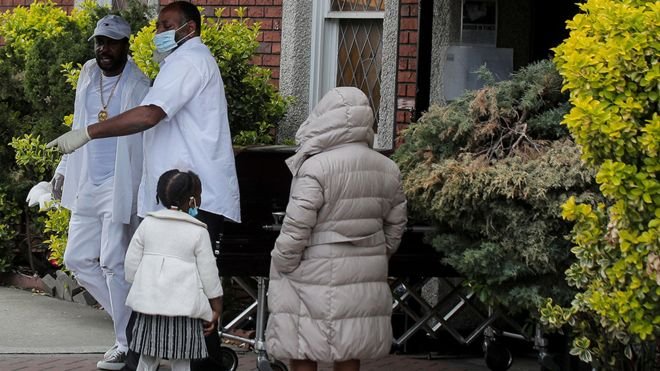 Pallbearers exit a funeral in Brooklyn