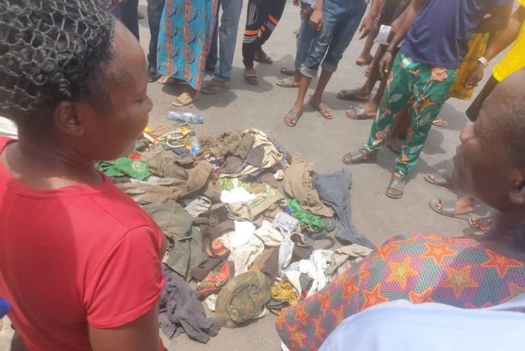 Residents gather around the drainage where the supposed madmen and suspected kidnappers reside in Shogunle, Oshodi