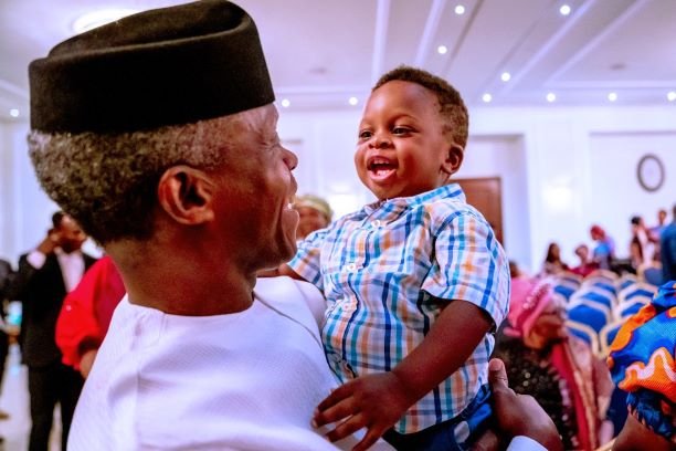 A baby boy shares a moment to cherish with Vice President Yemi Osinbajo