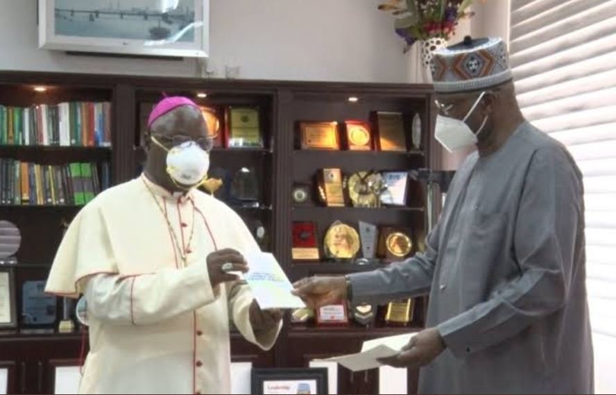 Nigerian Prelate of Catholic Church in Nigeria Archbishop Ignatius Kaigama presents the hospitals to Boss Mustapha