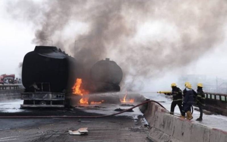 LASEMA operatives putting out the fire from an oil tanker on Lagos-Ibadan Expressway