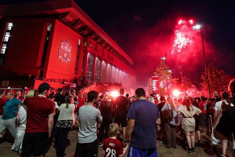 Liverpool fans celebrate winning the Premier League for the first time at Anfield