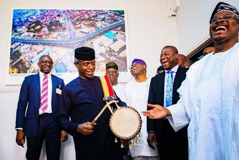 Vice President Yemi Osinbajo plays the drum to the amusement of late Governor Abiola Ajimobi and others