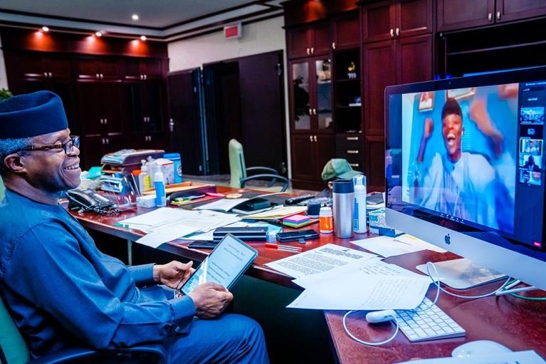 An ecstatic recipient of the 2020 MSMEs Awards celebrates as Vice President Yemi Osinbajo looks on