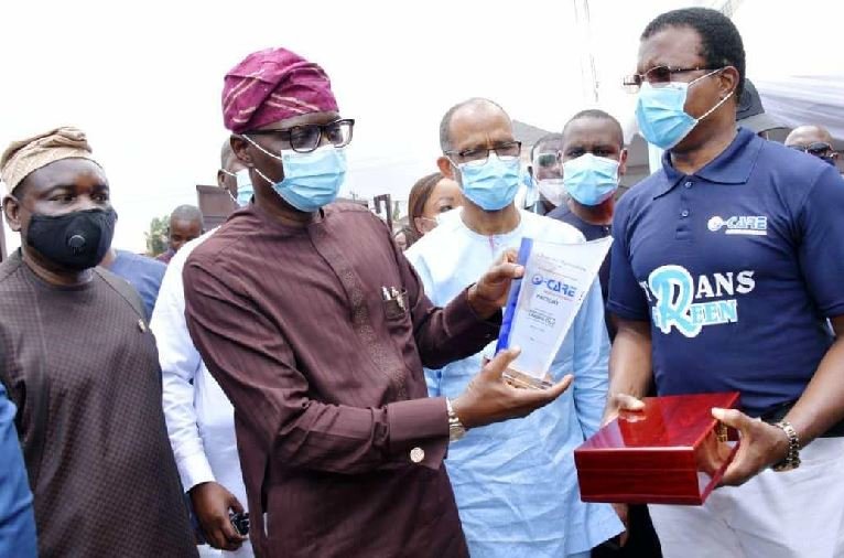 L-R: Lagos Commissioner for Information & Strategy, Mr. Gbenga Omotoso; Governor Babajide Sanwo-Olu, presented with a plaque; Commissioner for Health, Prof. Akin Abayomi and Managing Director of O-Care Medical Face Mask factory, Mr. Cyprian Orakpo during the official commissioning of the factory, at Odofin Park Estate, Amuwo Odofin, on Thursday, July 30, 2020.