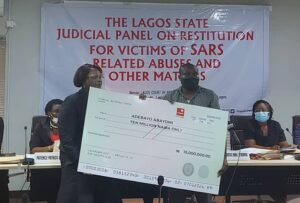 Adebayo Abayomi receiving the N10m compensation on behalf of his family