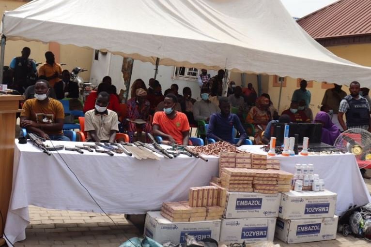 Police parade the criminals and some of the drugs that was seized from them