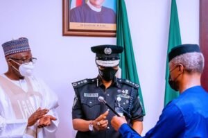 Vice President Yemi Osinbajo SAN decorates the new Acting Inspector General of the Nigerian Police Force Usman Alkali Baba at the State House, Abuja. 7th April, 202. Photos; Tolani Alli