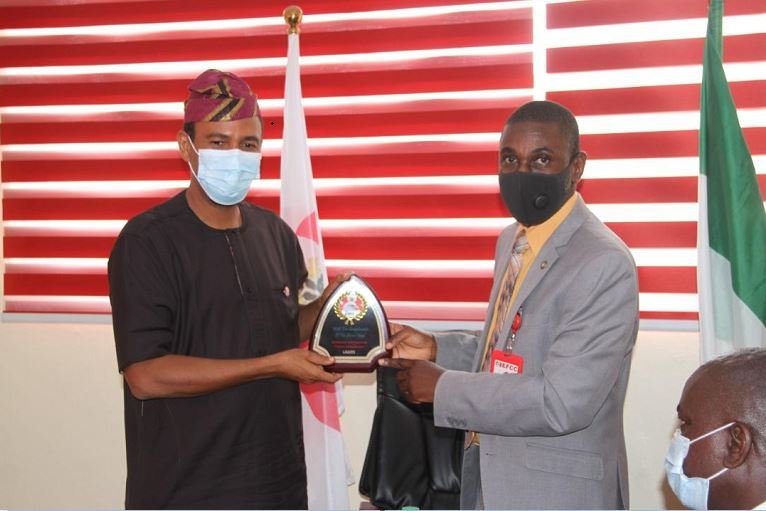 Lagos Head of EFCC, Ahmed Ghali presenting a plaque to MTN CEO, Karl Toriola