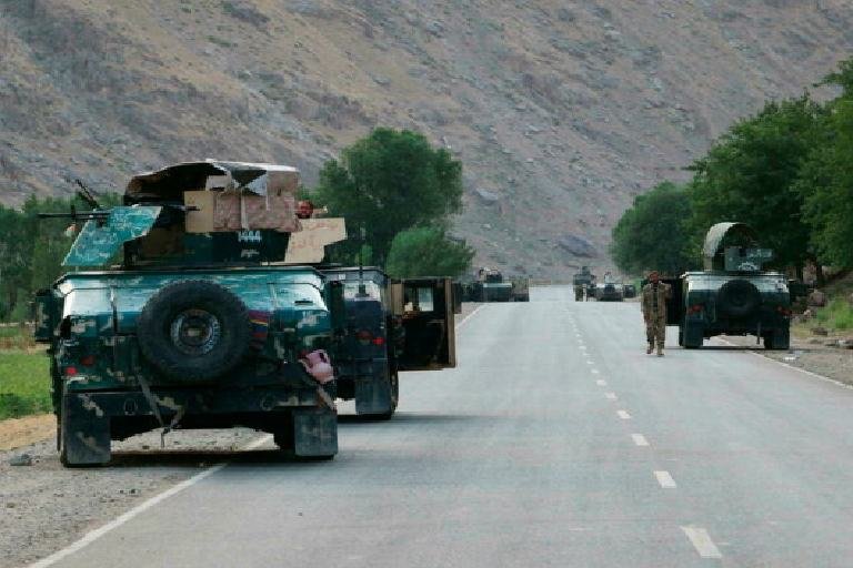Afghan soldiers pause on a road at the front line of fighting between Taliban and Security forces, near the city of Badakhshan, northern Afghanistan, Sunday, July. 4