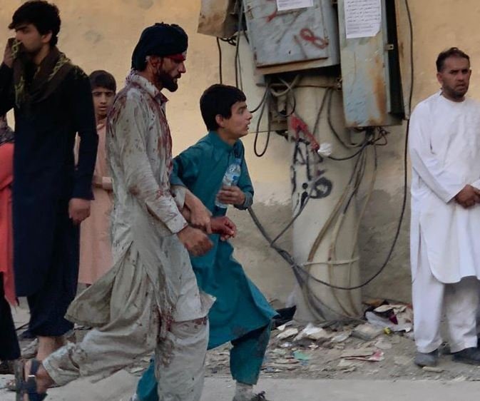 A man walking away bloodied after the explosion at the Baron Gate in Kabul, Afghanistan IS-K