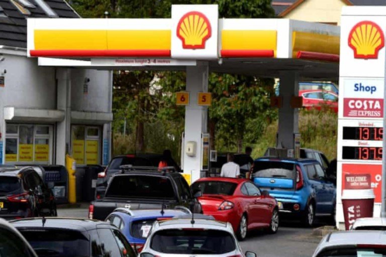 Cars queue for fuel at a Shell filling station in UK