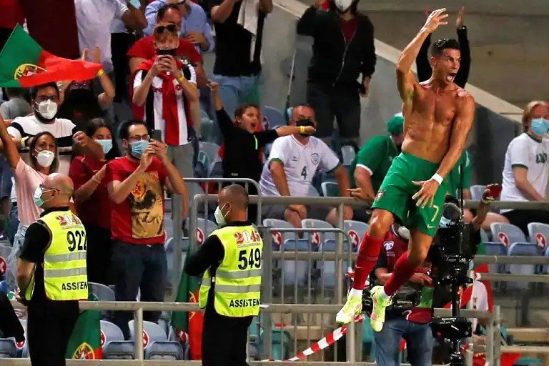 An ecstatic ronaldo took of his shirt to celebrate his record-breaking goal