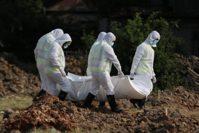 COVID-19 health workers burying the dead