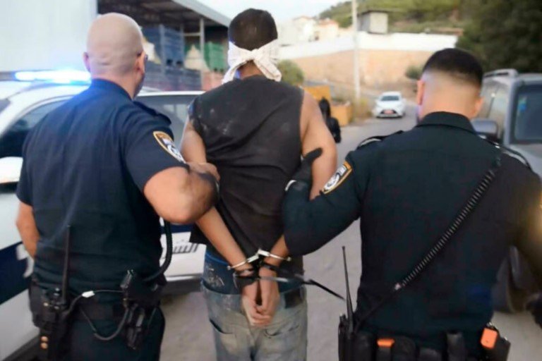 Zakaria Zubeidi is arrested by Israeli police officers in Umm al Ghanam, northern Israel, on September 11, 2021