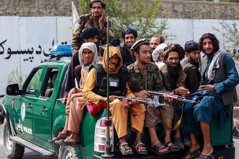 Taliban fighters wielding guns now control security in Afghanistan