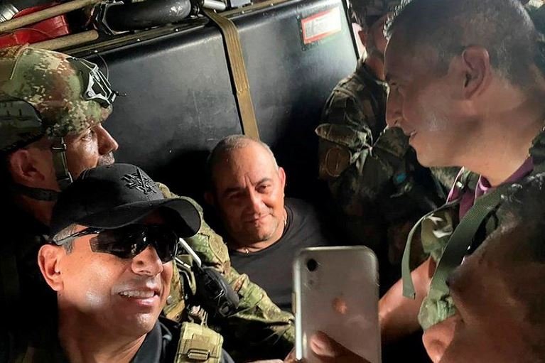 Otoniel was escorted by the security forces after his capture - and some posed for photos