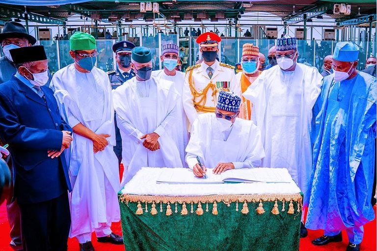 President Muhammadu Buhari signs a register on Nigeria's 61st Independence Day at the Eagle Square in Abuja on October 1, 2021